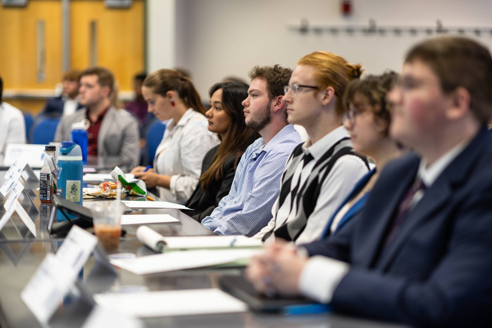 A row of student senators sitting at general assembly.